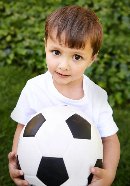 stock image Wanna see my cool soccer skills. an adorable little boy playing with a soccer ball outside