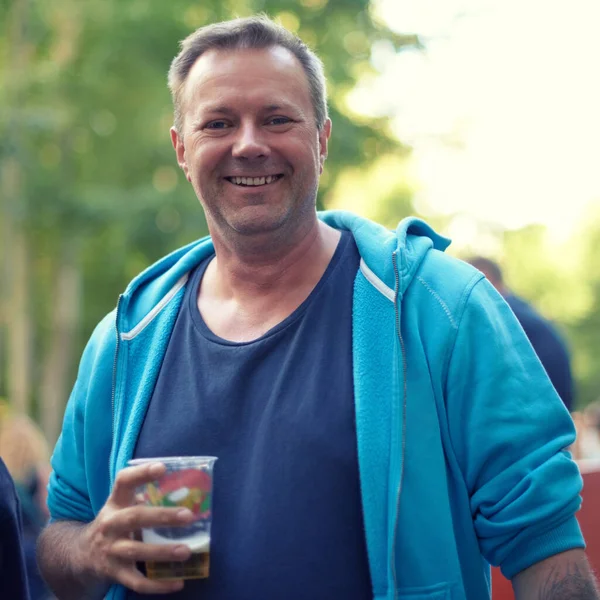 Beer festival time already. A man drinking beer at an outdoor event