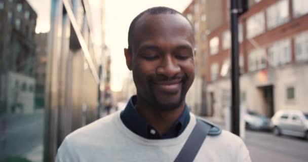 ビジネスマンは朝の通勤時にアメリカのニューヨーク市でコーヒーと一緒に歩くと電話ニュース ソーシャルネットワークや電子メールの更新ともに幸せな黒男飲み物テイクアウトラテで仕事に歩く — ストック動画