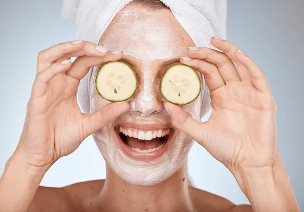 Spa, facial and woman with cucumber on eyes, fun portrait with cosmetic mask and detox cream. Skincare, beauty and cool face mask on happy model with smile with luxury cleaning skin care product