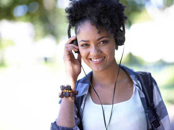 Feeling the beat. A young woman with headphones around her neck