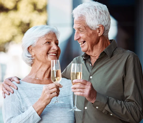 Senior couple, wine and toast outdoor, love or happiness celebration for anniversary or event together. Smile, happy or love with elderly man and woman with alcohol glass to celebrate and marriage.