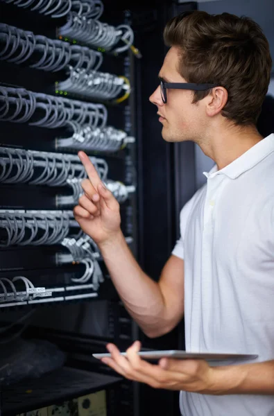 Taking care of your network needs. A computer technician fixing a server