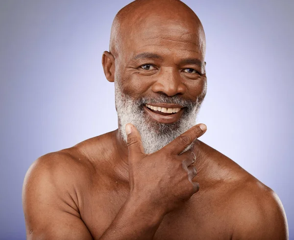 stock image Portrait, black man and facial skincare in studio for personal hygiene, clean face and natural cosmetics on grey background. Happy guy, mature male beauty and wellness spa for body care in Nigeria.