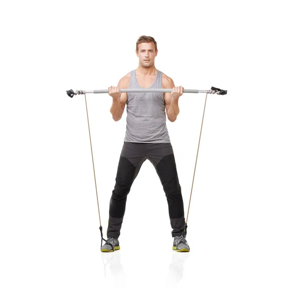 Stock image Working towards the body he desires. A young man working his upper body with a resistance band