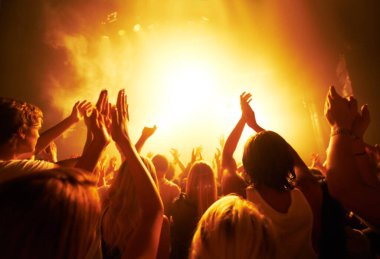 Müzik, konser ve ışık dolu kalabalık, canlı performans için alkış, rock etkinliği ve gece sahnede grup. İnsanlar, seyirciler ve müzik festivali, müzik ve ses müzik sanatçılarıyla birlikte gösteride..