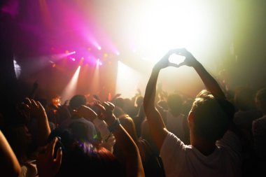 Crowd at concert, music and watch band performance, music festival, light and energy with audience back view. People dance with hands in heart shape, musician on stage and festival in Florida clipart