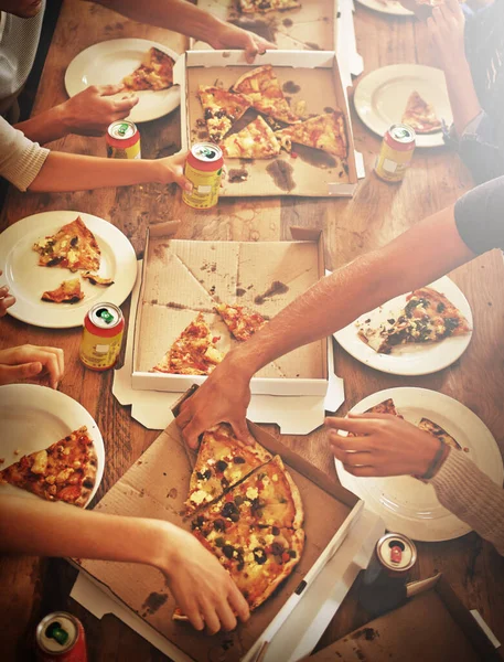 Top view of pizza, hands and people with food, drink and celebration, party or social gathering event at dining table. Group of friends, fast food and pizzas in lunch, dinner and restaurant cafeteria.