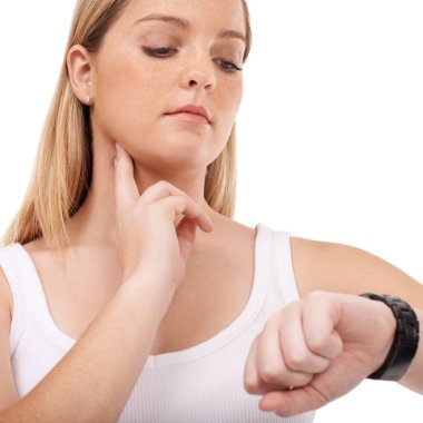 Monitoring her pulse rate carefully. Young woman taking her pulse rate against a white background clipart