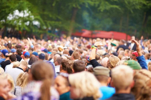stock image Cheering crowd. a large crowd standing outside and looking towards a stage at a music festival