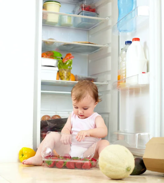 This looks tasty. a toddler eating food from the fridge