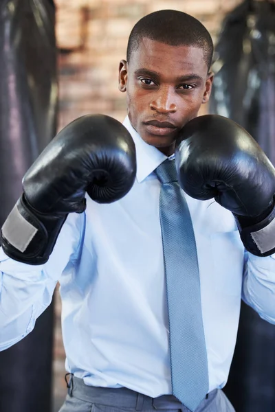 Im ready. A young african american boxer in a shirt and tie with his gloves up