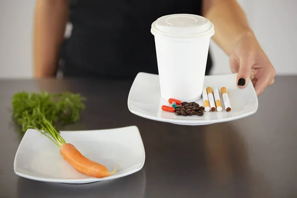 stock image Suppressing her appetite with coffee, cigarettes and diet pills. a young woman suffering from anorexia using appetite suppressants to eat less