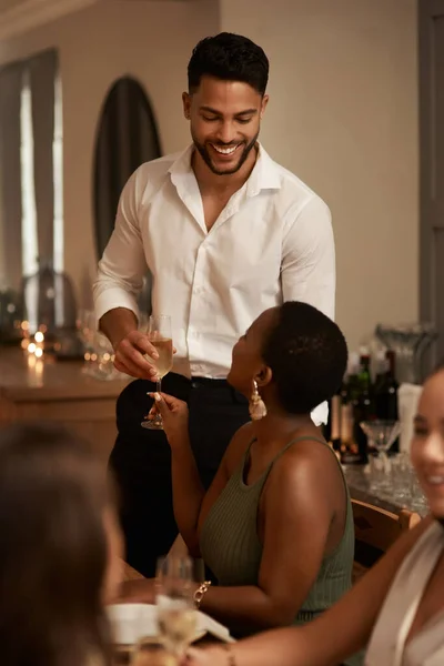 Young man, black woman and date with glass champagne or dinner party in restaurant. New Years, friends and alcohol drink with smile for celebration, success and happiness at social event to relax.