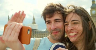 Çift, selfie için seyahat ve telefon, video görüşmesi ya da hafıza aşk ve özgürlük için kalp emojisi elleri ile Londra 'da tatil ve yolculuk. Turist gezisinde kadın ve erkek arasında mutluluk.