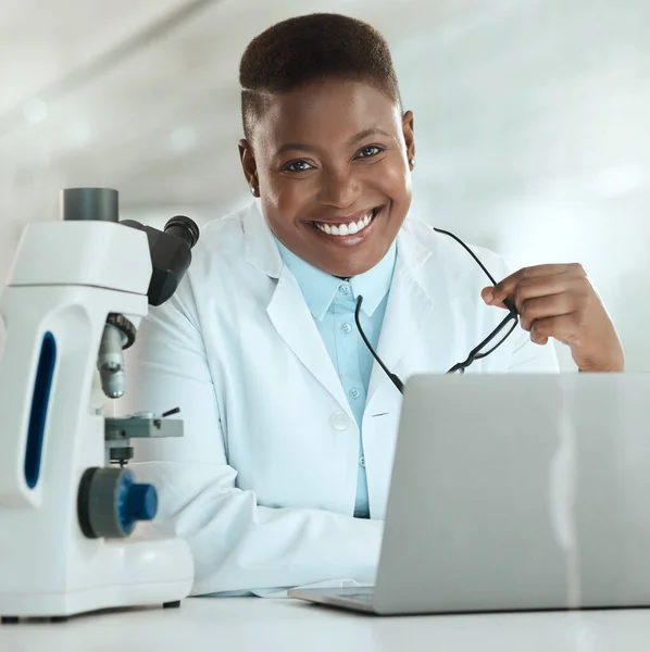 Working towards a better future. an attractive young scientist sitting alone in her laboratory and using her laptop