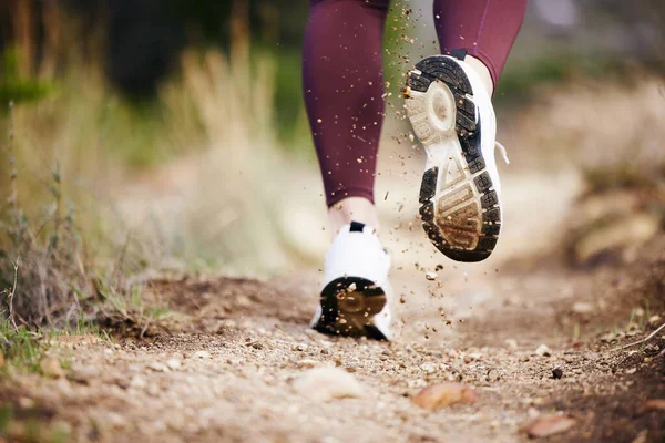 Foot, dirt and running in nature for fitness, exercise and athletic training for health and wellness. Footwear, trail and cardio jogging in running shoes for sporty, physical and healthy lifestyle.