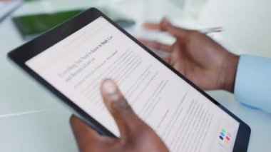 Black lawyer or law student hands doing research, highlight key notes or points on digital tablet. Closeup of inspired male looking up information on internet about college education with stylus pen