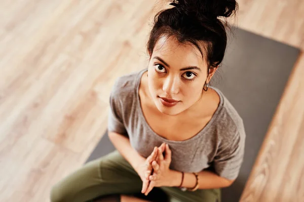 You are your own altar. a young woman meditating during a yoga session