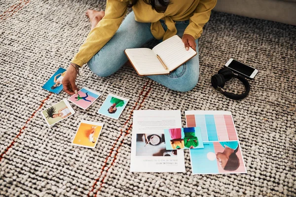 I think this picture will look great on my blog. an unrecognizable businesswoman sitting on her living room floor and going through polaroids for her blog