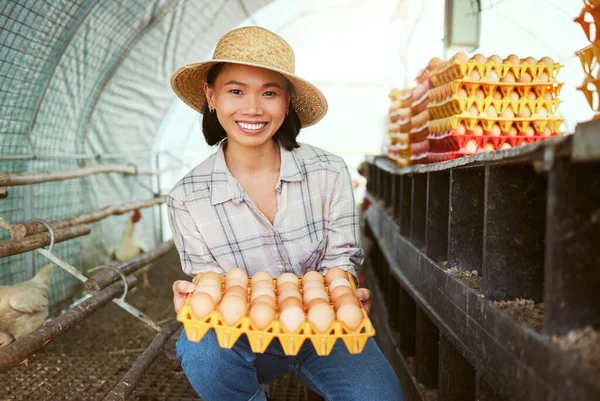 Chicken eggs, woman and portrait of farmer with tray of fresh, organic and healthy protein of animal coop in Japan. Poultry farming, sustainable production and food economy in eco friendly hen house.