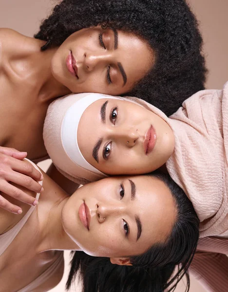Portrait, beauty and diversity with woman friends in studio on a brown background for skincare or inclusion. Face, pile and natural with a model female friend group posing to promote equality.