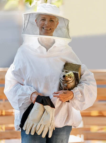 Beekeeper woman, safety portrait or farm with apiculture suit, vision or smile in summer harvesting time. Bee expert, ppe clothes or happiness in eco friendly manufacturing, small business or success.