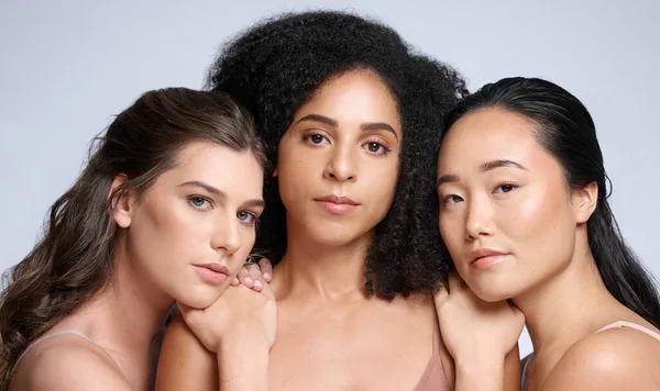 Skincare, beauty and diversity of women for makeup marketing, dermatology wellness and cosmetics against a grey studio background. Spa, support and face portrait of the skin of model friends.