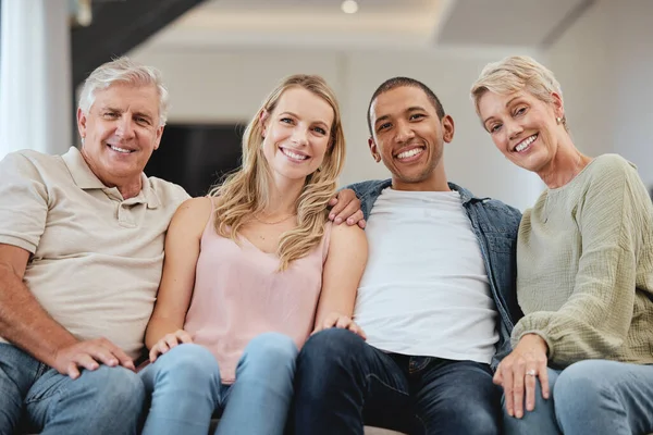 Family, portrait and relax in living room home, bonding and having fun. Interracial love, diversity and care of happy grandparents, man and woman, smiling and enjoying quality time together in house