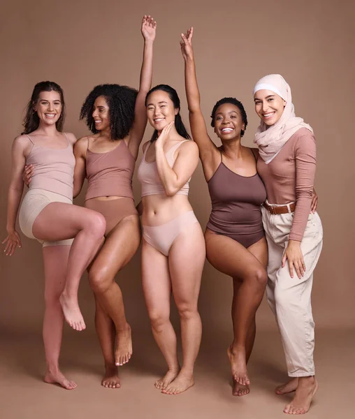 Beauty, diversity and group of women in studio for wellness, fashion and body positivity on brown background. Self care, support and females celebrate natural skincare, self love and healthy skin.