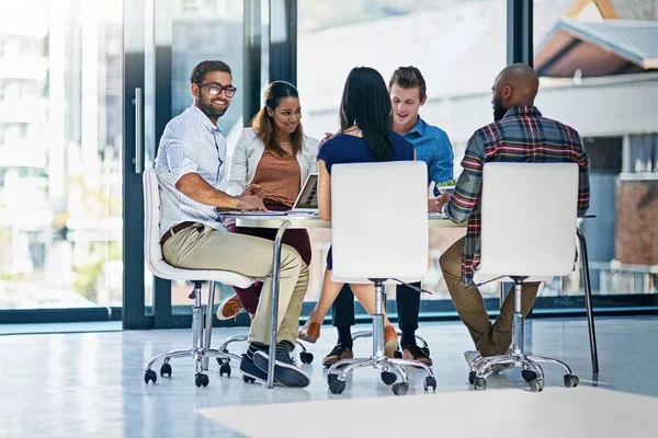 As you can see the meeting is clearly going well. a group of young businesspeople discussing ideas with each other during a meeting in a modern office