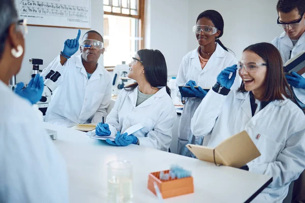 College, science and education with students in laboratory classroom for medicine, learning and research. Question, analysis and help with people and professor for university, study and healthcare.