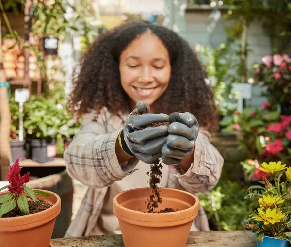 Black woman, garden and soil with plant and environment, happy gardener with dirt and nature, growth and sustainability. Spring, natural and gardening with earth, agriculture and compost for flowers