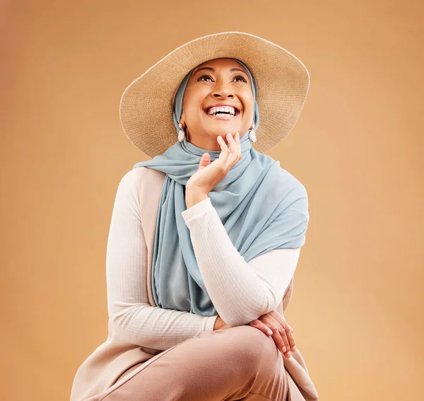 Hijab, fashion and happy woman thinking on studio background, trendy hat and summer style. Laughing, happiness and mature muslim model, islamic culture and beauty for positive mindset, ideas or smile.