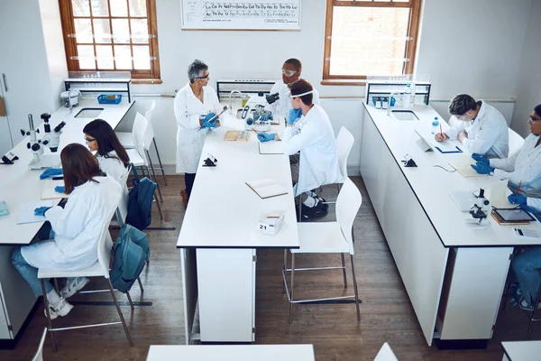 Education, science and students in lab classroom with professor and equipment for test. Technology, innovation and learning in laboratory at forensic research facility or school for future scientist