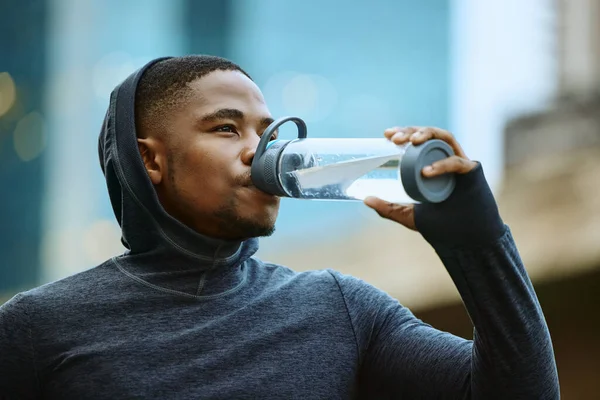 Fitness, drinking water or black man face for exercise, cardio training or running goal. Tired runner, sports or athlete man with water bottle for wellness marathon, city race workout or thirst.