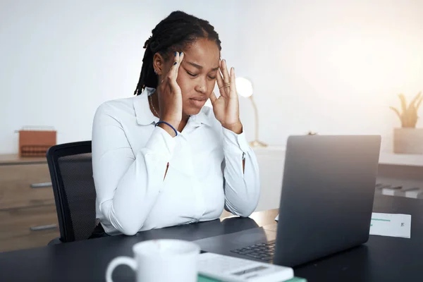 Headache, stress and burnout of black woman with anxiety, pain and doubt while working on laptop audit. Tired, sick and confused business worker, poor mental health and computer glitch at office desk.