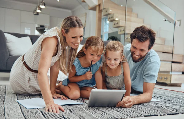 Family, online learning and kids with tablet in living room, studying and bonding with parents. Homework, distance learning and education with father, mother and girls watching educational video