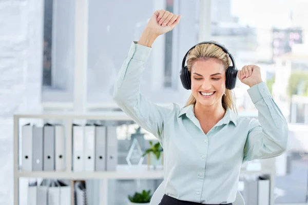 Business woman, happy office and headphones for dancing and listening to music to celebrate achievement, success or bonus after reaching target or goal. Entrepreneur doing winning dance to sound.