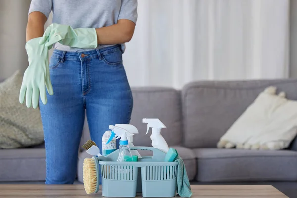 Black woman hands for cleaning, product in basket on table for home maintenance tools or living room spring cleaning. Cleaner, container or maid with brush or liquid spray bottle for cleaning service.
