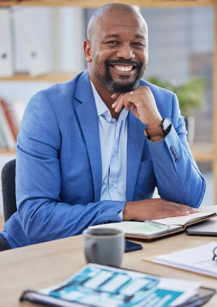 Happy black man, business manager and ceo working at modern office desk as financial investor, stock market trader and corporate worker in Nigeria. Portrait smile of african executive leader and boss.