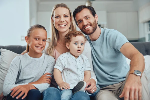 Happy, family and sofa portrait with kids at home in Australia for bonding and togetherness. Family home, mother and dad with young children relaxing on living room couch with joyful smile