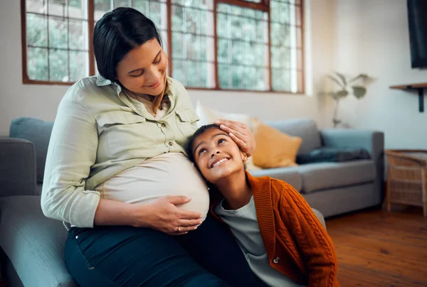Pregnancy, family and girl with pregnant mother listening to newborn baby with love, affection and bonding. Family home, maternity and mom on sofa with child with ear to pregnant belly in living room.