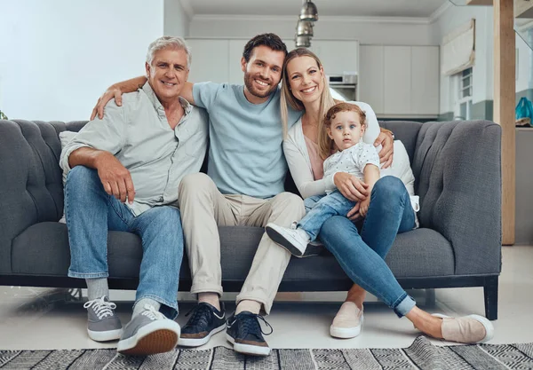 Family, happy portrait and relax on sofa in living room for quality time, relationship bonding and happiness together. Big family, smile and grandfather relaxing with children on couch for support.