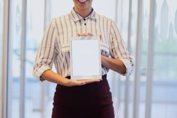 Online is the best place to advertise. Closeup shot of an unrecognizable businesswoman holding up a digital tablet with a blank screen in an office
