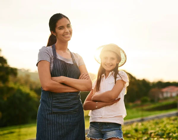 We know how to work a farm. Cropped portrait of an attractive young woman and her daughter standing with their arms folded on the family farm