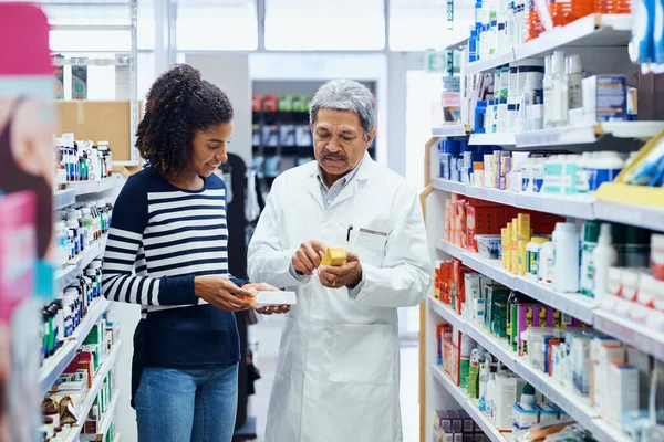This is one of the best products on the market. a pharmacist assisting a young woman in a chemist