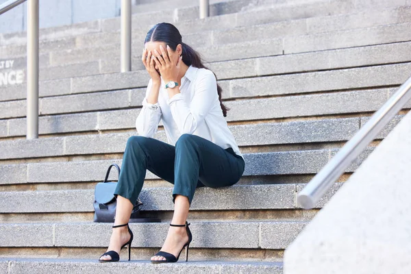 Business woman on stairs, stress and burnout for work, tired and overworked. Young female or entrepreneur on steps, crying and frustrated with debt, mental health and depression after fired from job.