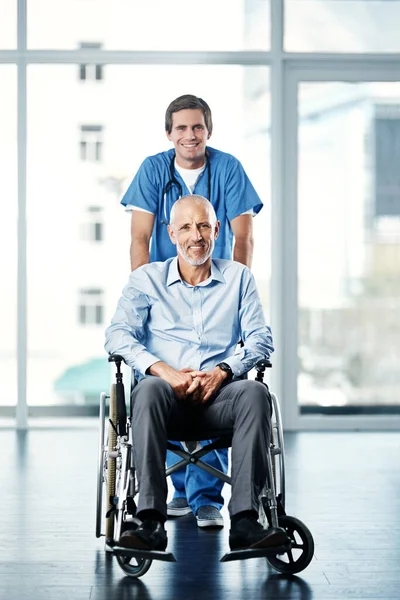 Ive got only his best interests at heart. Portrait of a male nurse caring for a senior patient in a wheelchair