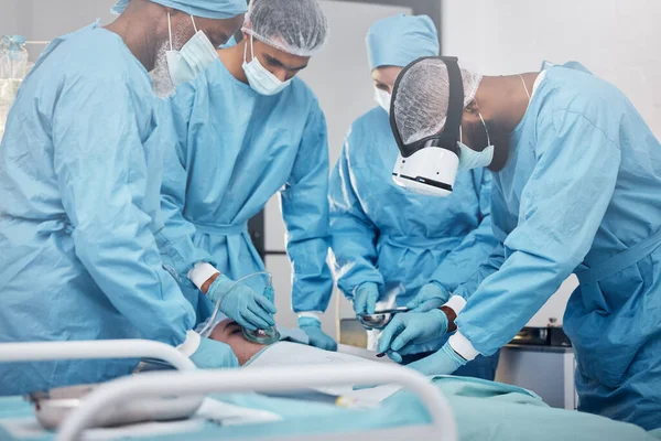 Doctors, surgery and collaboration with a medicine team in scrubs operating on a man patient in a hospital. Doctor, nurse and teamwork with a medical group in a clinic to perform an operation.